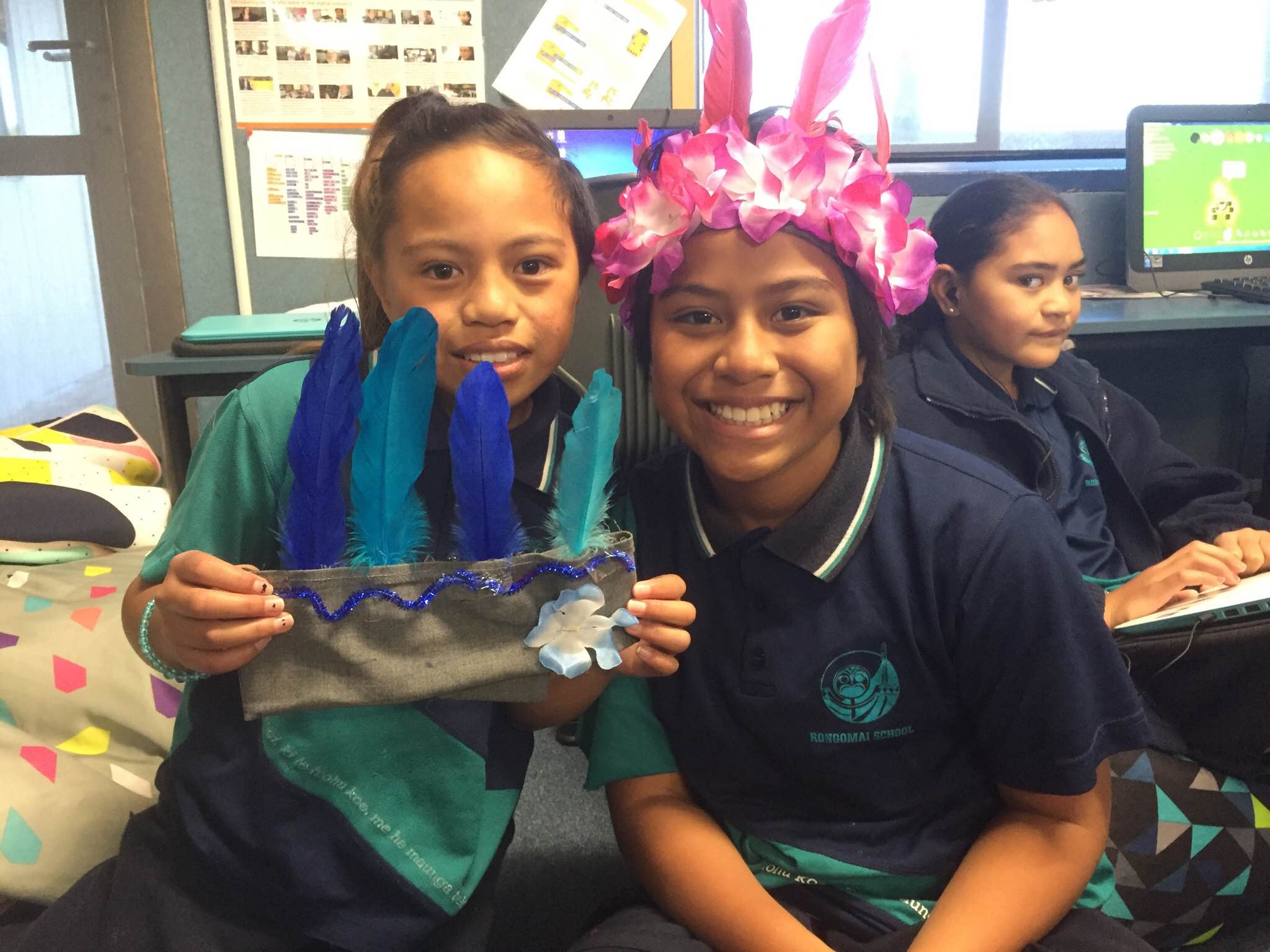 Two kids making hats